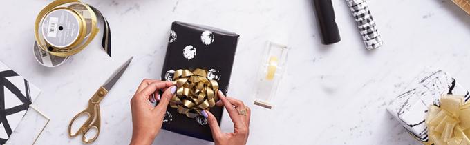 Gold and black gift wrap supplies by Hallmark including ribbon, bows, wrapping paper & tissue paper